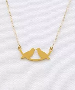 A string of birds on a small golden swing