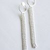 Long silver curving earrings