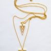 A long chain is double geometric and gilt charm