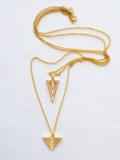A long chain is double geometric and gilt charm