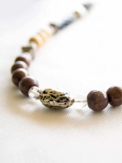 A long Bohemian brass necklace with silver plated, wooden beads, gemstones, basalt stones