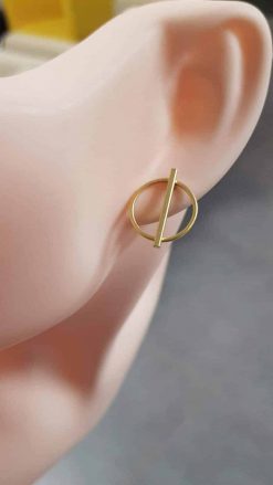 Golden circle earrings attached to the ear